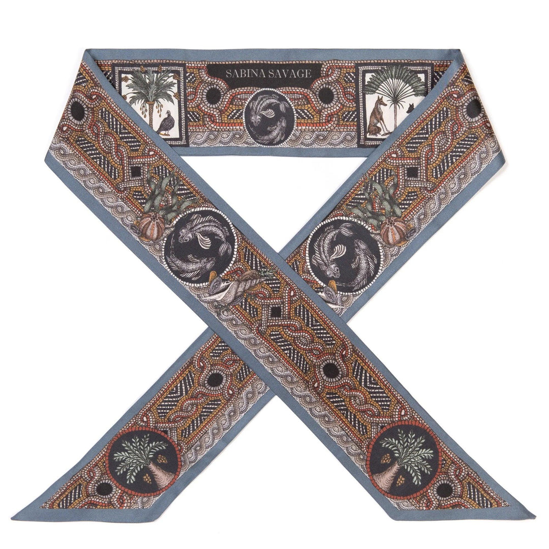 Sabina Savage aqua silk ribbon featuring intricate hand-drawn mosaic-style illustrations of animals and palm trees.