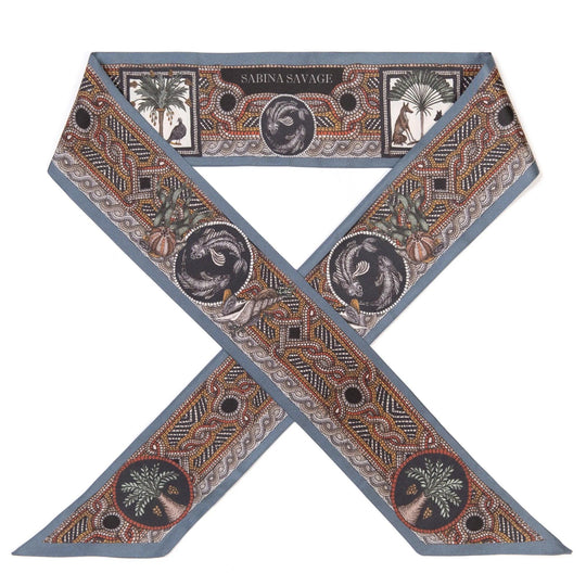 Sabina Savage aqua silk ribbon featuring intricate hand-drawn mosaic-style illustrations of animals and palm trees.