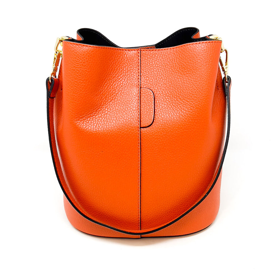 Orange leather handbag with a gold clasp on a white background