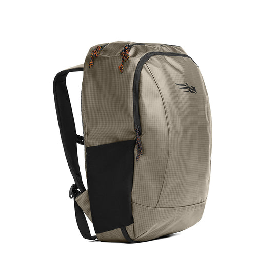 Sitka Drifter travel pack in olive ripstop fabric with black mesh side pocket, zipper pulls, and padded shoulder straps.