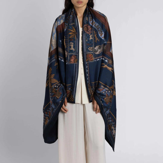 Navy blue cashmere stole featuring intricate American folk art motifs, bison illustrations, and symbolic emblems.