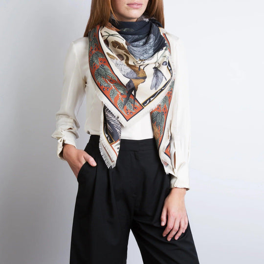 Sabina Savage wool-silk scarf featuring an albino alligator and heron print with hand-fringed edges on a model.