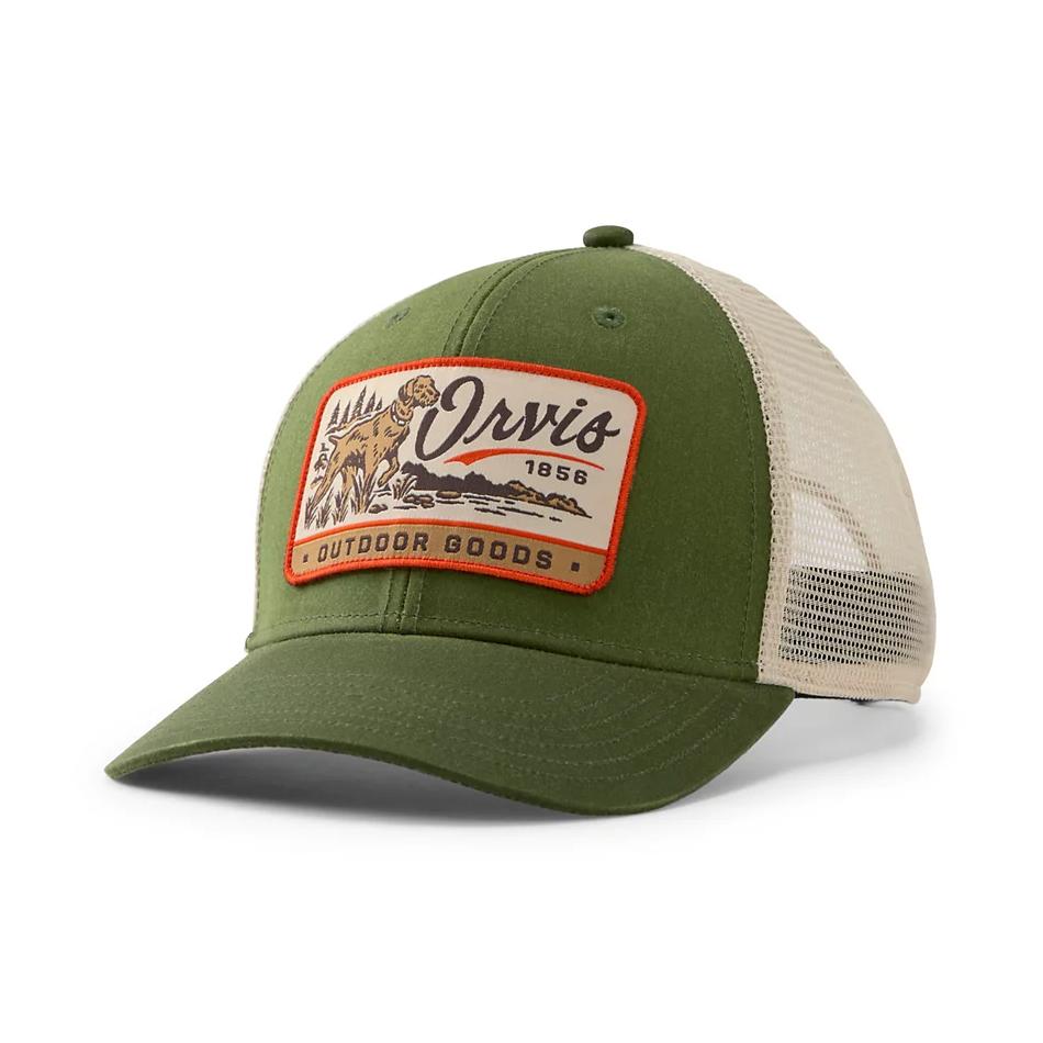 An olive green and beige trucker hat with a front patch reading 'Orx's 1956 Outdoor Goods' featuring a mountain and tree illustration, shown on a white background.