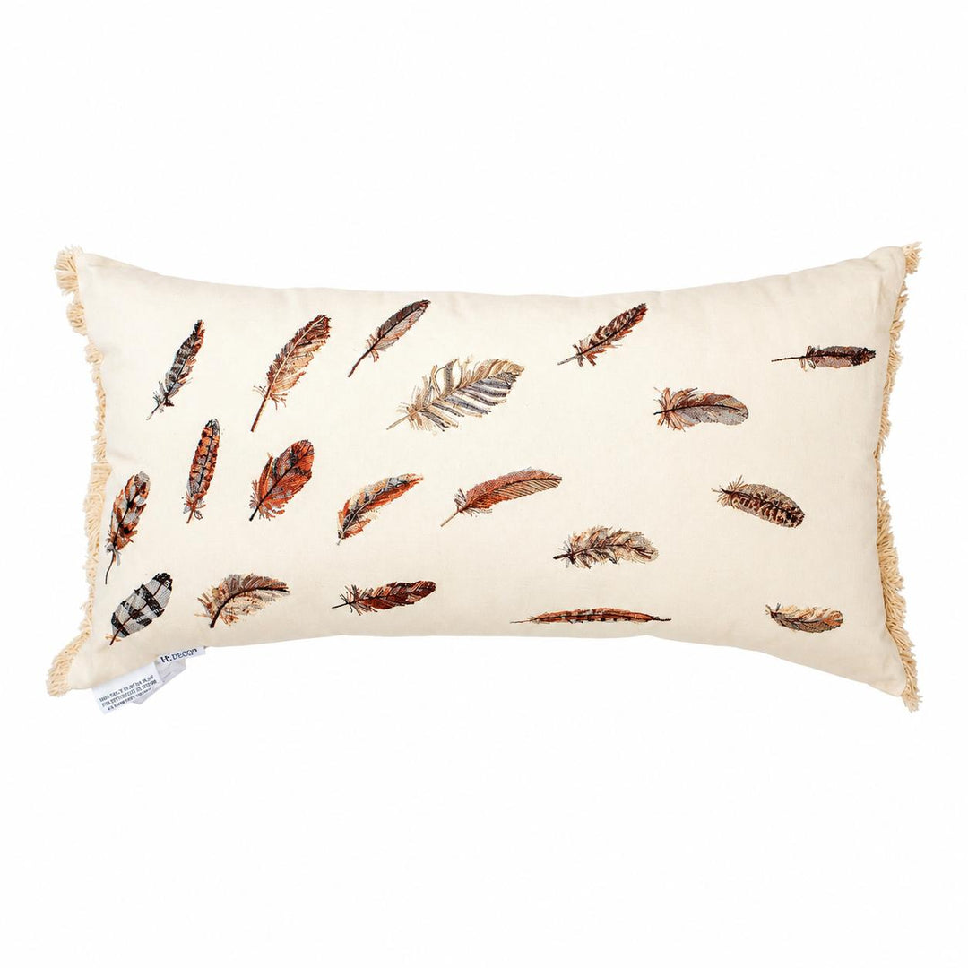 An off-white rectangular lumbar pillow with fringed edges, decorated with a pattern of various brown, orange, and gray feathers, shown on a plain white background.