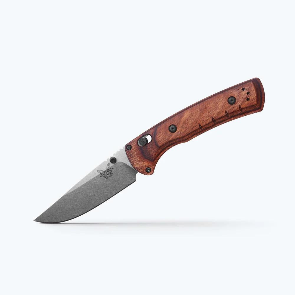 Folding knife with a wooden handle on a white background