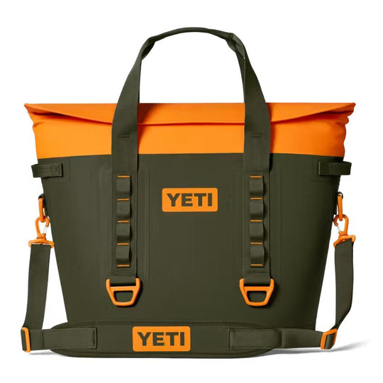 Olive green and bright orange YETI Hopper M30 soft cooler with magnetic top closure, carry handles, and shoulder strap.