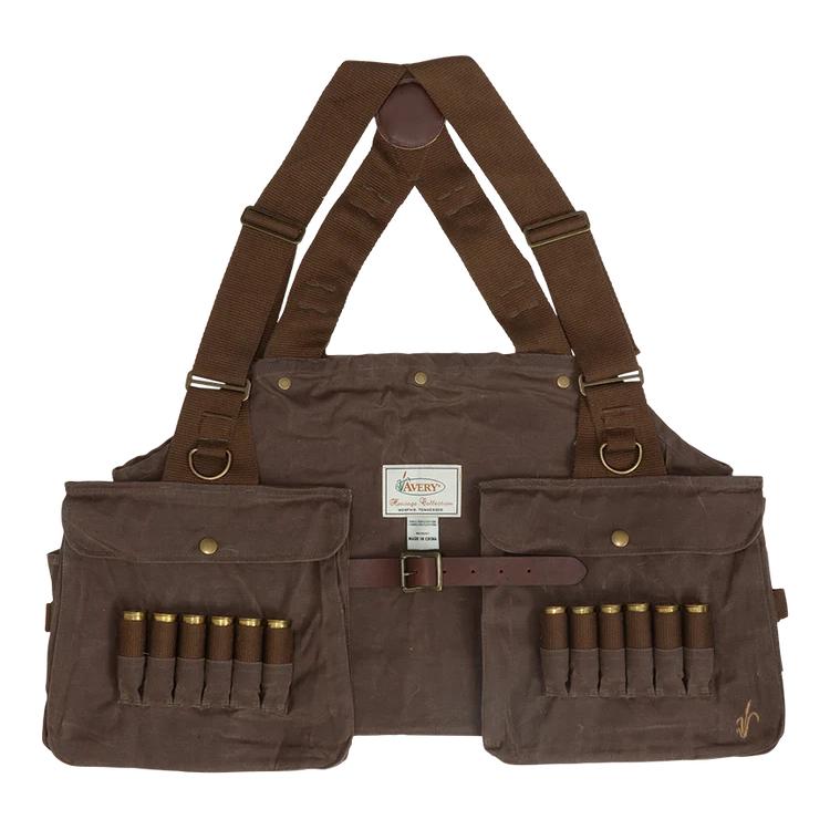 A brown canvas shotgun carrier with adjustable shoulder straps, front pockets, and magazine loops holding shotgun shells, shown against a plain white background.