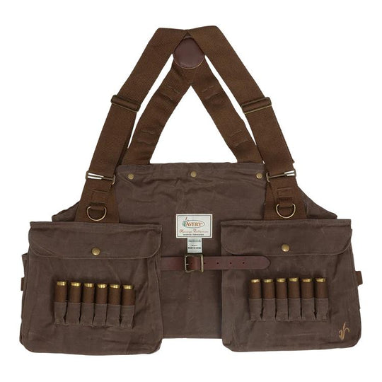 A brown canvas shotgun carrier with adjustable shoulder straps, front pockets, and magazine loops holding shotgun shells, shown against a plain white background.
