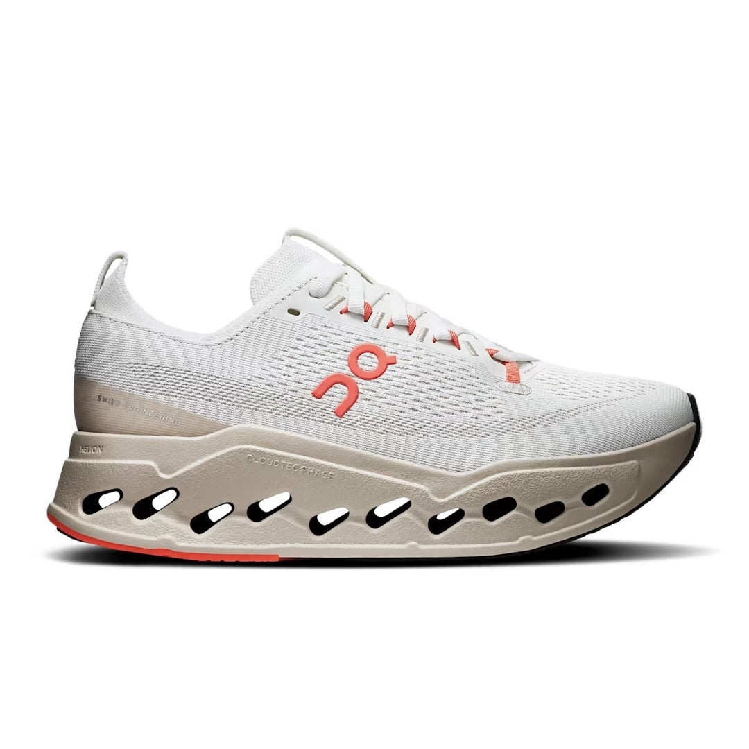 On Running Women's Cloudsurfer Max in beige with orange accents, featuring a thick, cut-out CloudTec Phase foam sole.