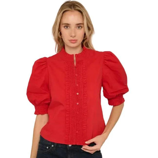 Red cotton Zinny top featuring a button-front design, delicate trim detailing, and romantic puff sleeves with smocked cuffs.