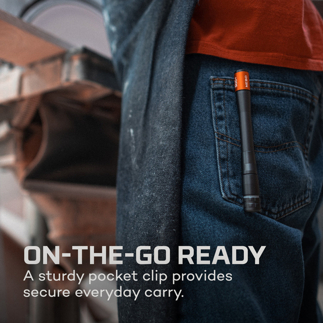 Black and orange NEBO Inspector 500+ penlight clipped securely to a pair of blue jeans for everyday carry.