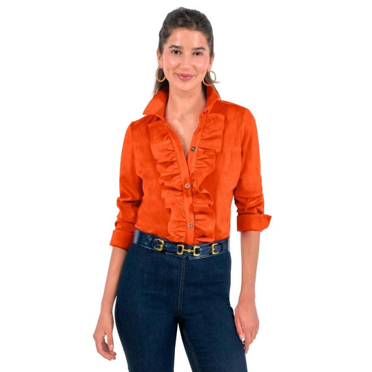 Orange ultra suede button-down blouse with a ruffled front placket, collar, and gold buttons worn with dark denim jeans.