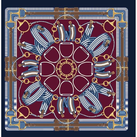 Square silk twill scarf in burgundy and blue with a symmetrical equestrian pattern of stirrups, reins, and gold bits.