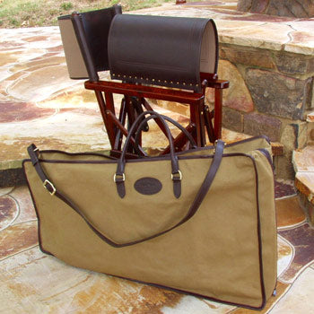 Tan canvas carrying case with leather trim, handles, and shoulder strap for a folding campaign salon chair.